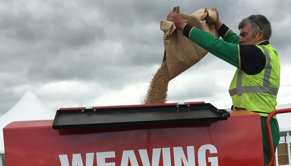 A man filling a seed drill at the Cereals 2017 event.